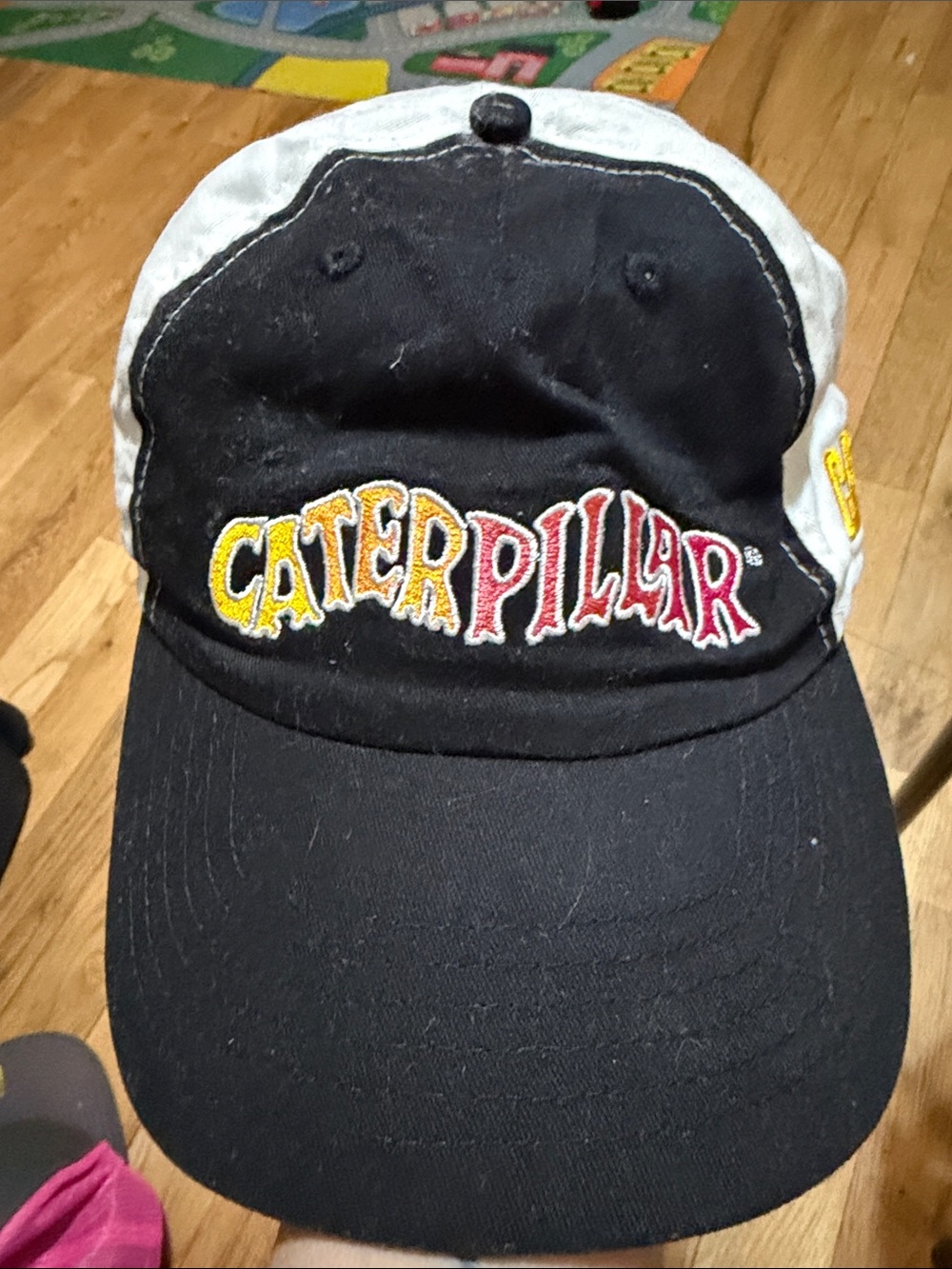 Caterpillar Black and White Hat with Yellow and Red Logo